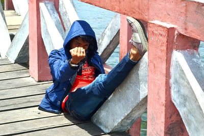 Full length of boy sitting outdoors