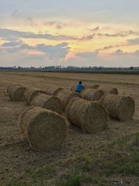 Scenic view of field against cloudy sky