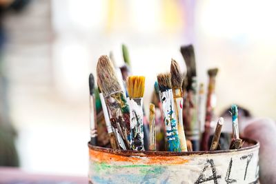 Close-up of paintbrushes in container