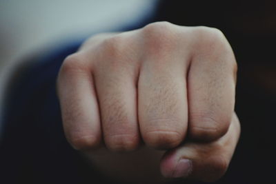 Close-up of person clenching fist