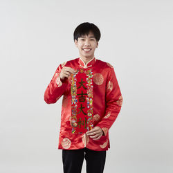 Portrait of a smiling young man against white background