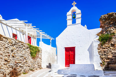 Mykonos, greece. whitewashed small church, little venice, travel spotlight greek islands.