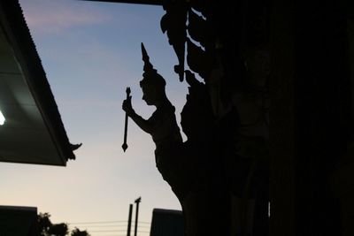 Low angle view of silhouette man against sky