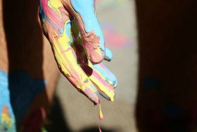 Low section of woman with multi colored flower