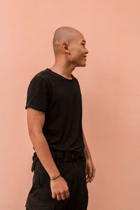 Young man looking away against white background