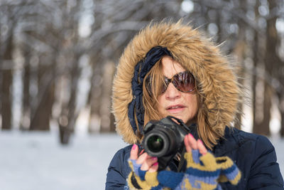 Young woman photographing with camera