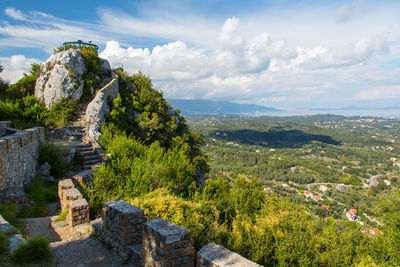 Scenic view of green corfu island against sky