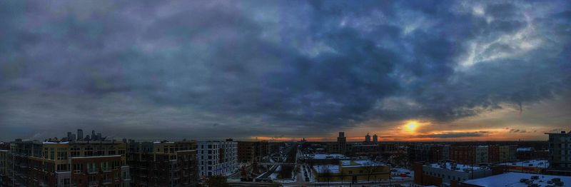 View of cityscape against cloudy sky