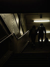 Rear view of people walking in subway