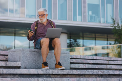 Entrepreneur using smart phone while working outdoors