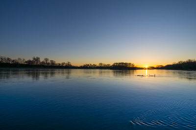 Scenic view of calm sea at sunset