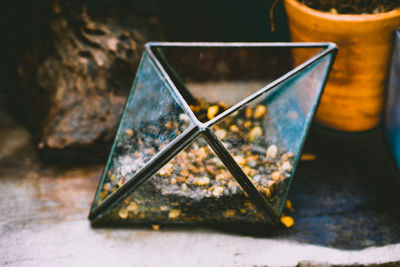 Close-up of broken glass on table