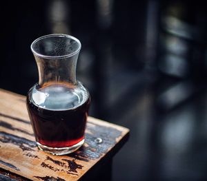 Close-up of red wine carafe on table