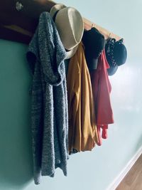 Close-up of clothes drying against wall at home