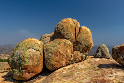 Rock formation against clear blue sky