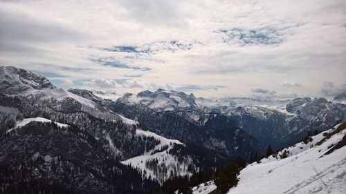 Scenic view of mountains against cloudy sky