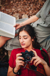 High angle view of woman photographing with mobile phone