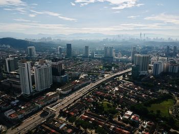 High angle view of modern buildings in city against sky