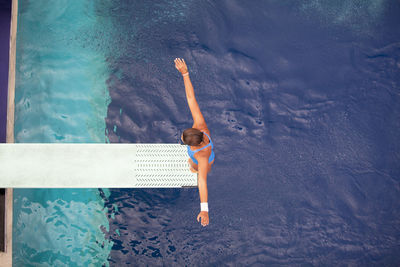 High angle view of woman swimming in pool