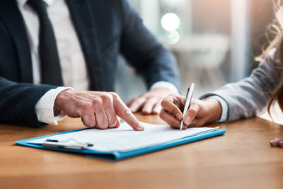 Midsection of businessman working at table