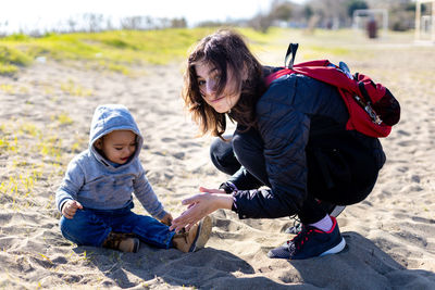 Side view of family walking on beach