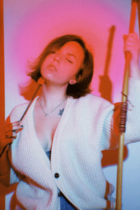 Young woman playing with arms raised