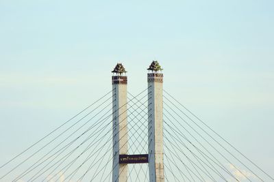 Low angle view of suspension bridge against sky