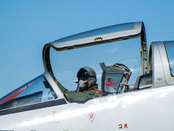 Man on airplane against clear sky