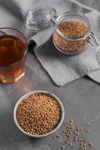 Bowl of fenugreek seeds and egyptian fenugreek yellow tea or methi dana drink