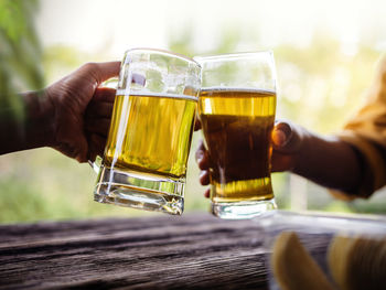 Midsection of woman holding beer glass