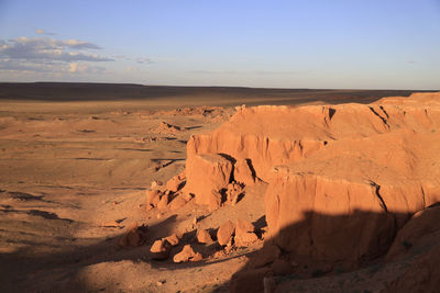 Scenic view of desert against sky during sunset