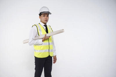 Portrait of man standing against white background