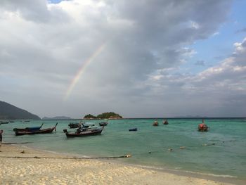 Scenic view of rainbow over sea against sky