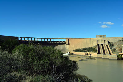 Dam against blue sky on sunny day