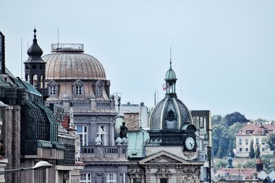 Buildings in city against clear sky