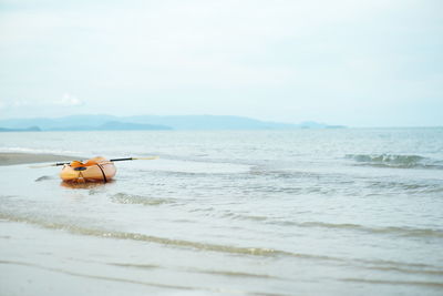 Empty kayaking on sea against sky