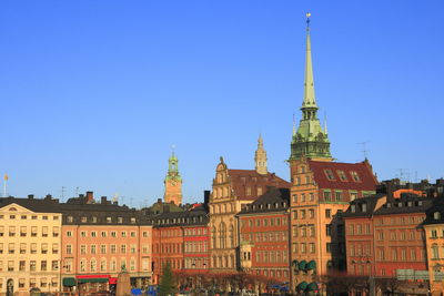 Low angle view of buildings against blue sky