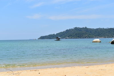 Scenic view of sea against blue sky