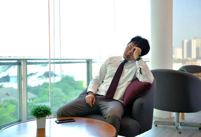 Businessman sitting on chair in office