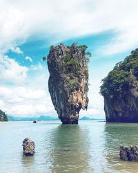 Scenic view of rock formation in sea against sky