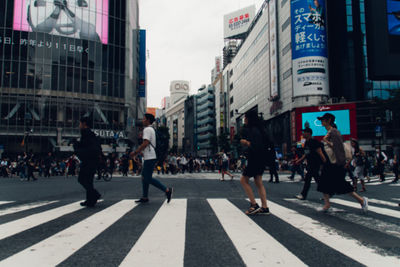 Group of people walking on city street