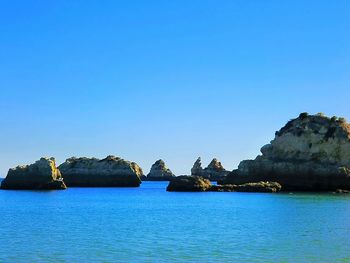 Scenic view of sea against clear blue sky