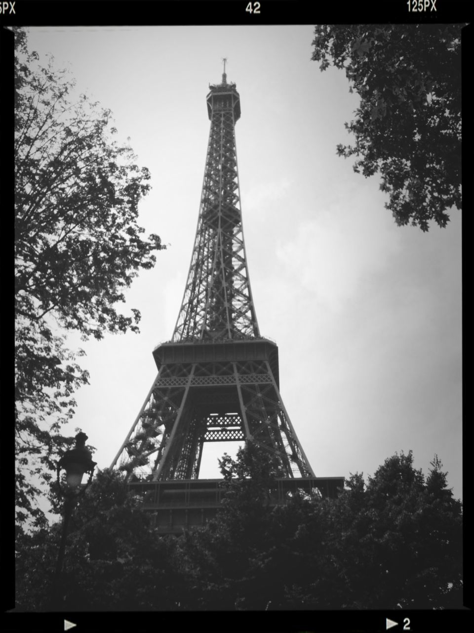 eiffel tower, tower, architecture, built structure, low angle view, tall - high, tree, famous place, international landmark, culture, travel destinations, sky, tourism, history, capital cities, travel, building exterior, transfer print, auto post production filter, tall