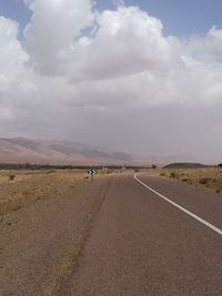 Road by landscape against sky