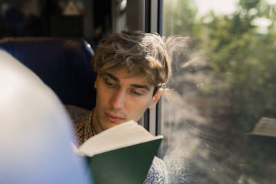 Portrait of young woman reading book