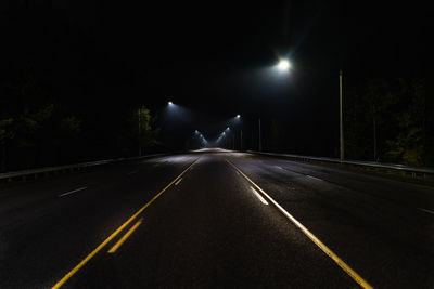 Street light trails on road at night