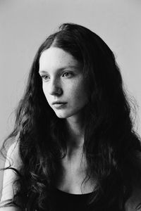 Portrait of beautiful woman against white background