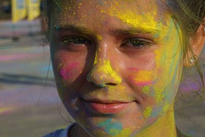 Close-up portrait of girl with paint on face