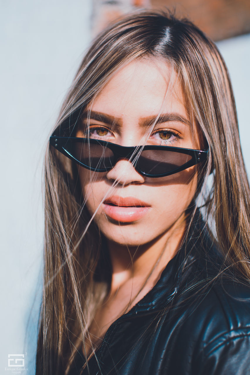 portrait, headshot, one person, glasses, hair, women, young adult, long hair, hairstyle, front view, real people, young women, sunglasses, close-up, lifestyles, looking at camera, indoors, adult, fashion, beautiful woman, human face