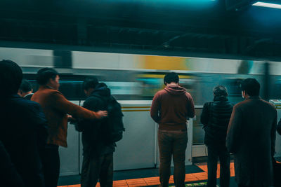 Rear view of people at subway station